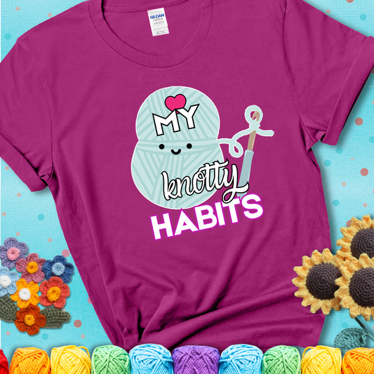 Smiling yarn ball and hook with text “Love My Knotty Habits” - cute crochet shirt with playful design for makers, showing a magenta tee with a teal sunflower background