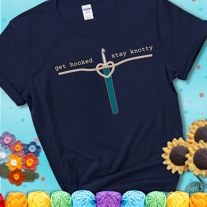 Hooked on yarn? Same Design reads 'Get Hooked, Stay Knotty' , perfect crochet gift for yarn lovers, showing a navy blue tee with a teal sunflower background