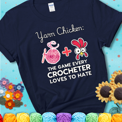 Cartoon chicken inside a yarn ball with crochet circle background. Text reads: “Yarn Chicken: The Game Every Crocheter Loves to Lose.” A fun and relatable tee for fiber artists who like to live on the edge, showing a navy blue tee with a teal sunflower background