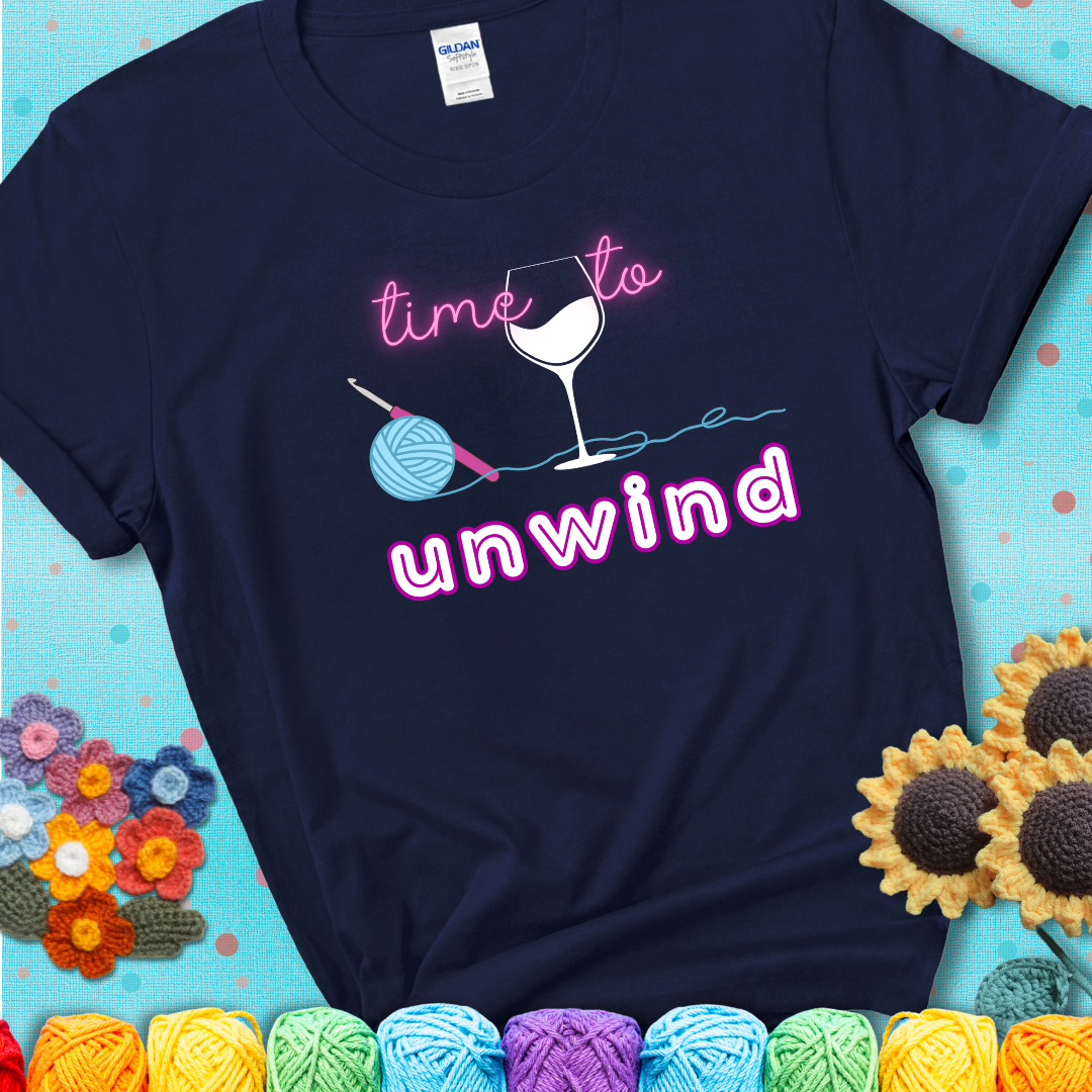Wine down with your yarn out Design reads 'Time To Unwind' , perfect crochet gift for yarn lovers showing a navy blue tee with a teal sunflower background