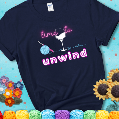 Wine down with your yarn out Design reads 'Time To Unwind' , perfect crochet gift for yarn lovers showing a navy blue tee with a teal sunflower background