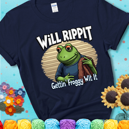 Cool frog holding a yarn blanket. Text reads: “Will Rippit Gettin’ Froggy Wit It.” A hip and humorous crochet navy blue tee for yarn lovers with rhythm.