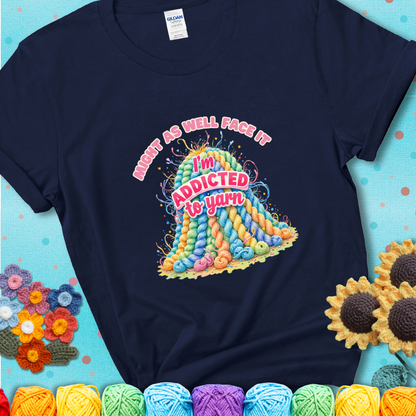 Navy Blue t-shirt with a colorful mountain of pastel yarn hanks and the phrase “Might As Well Face It, I’m Addicted To Yarn” in pink and red lettering.