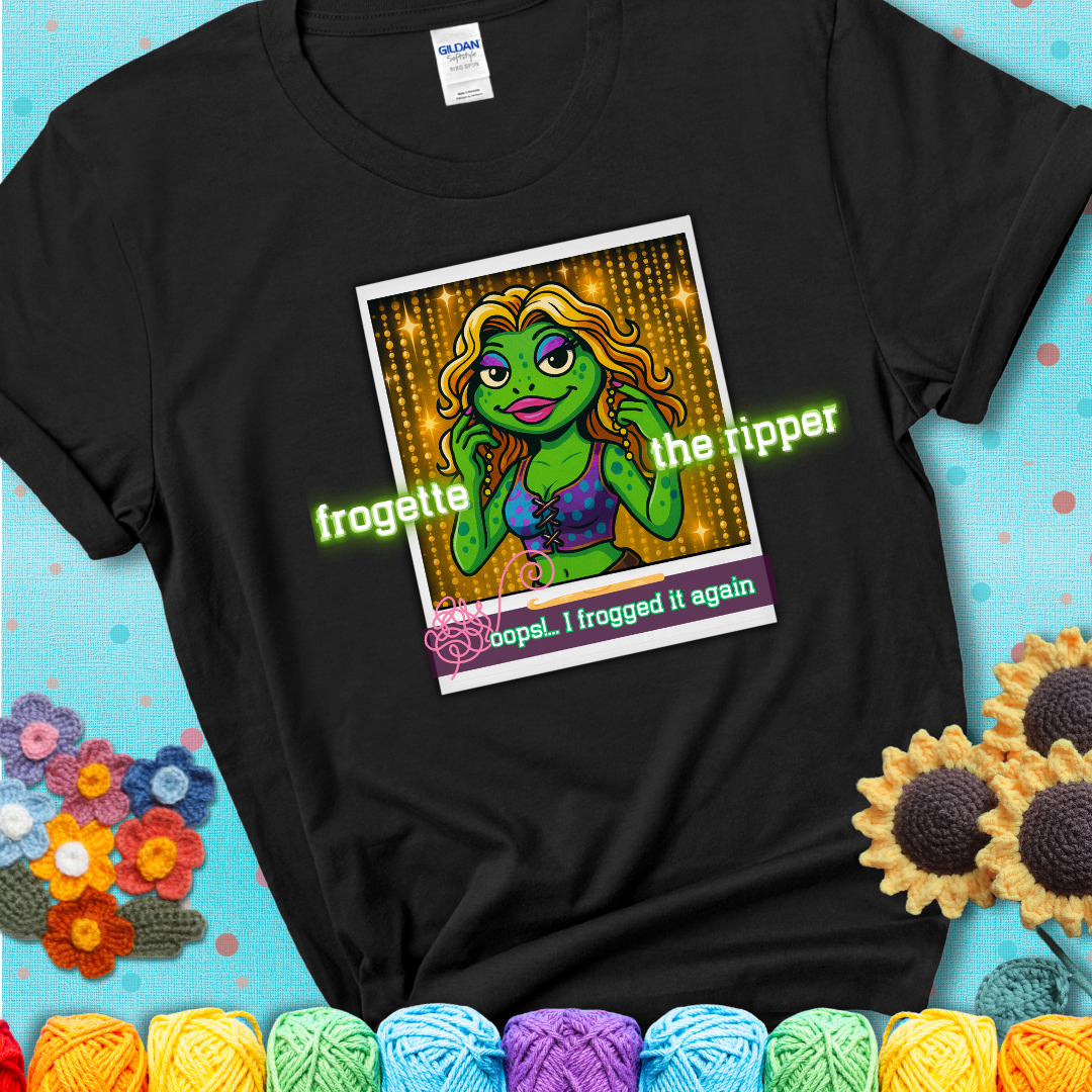 Retro-styled illustration of a glamorous green frog in a sparkly outfit, labeled "Frogette the Ripper" with the phrase “Oops! I frogged it again” below, referencing both crochet and pop culture showing a black tee with a teal sunflower background