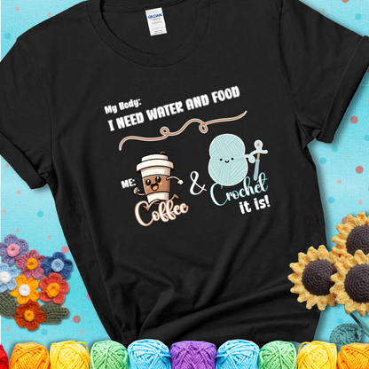 Design reads “My body: I need water and food. Me: Coffee & Crochet it is,” with a smiling coffee cup and yarn ball characters on a black t-shirt.