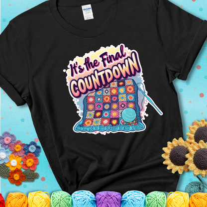 Black t-shirt with a colorful crochet blanket in progress, blue yarn ball, crochet hook, and the phrase “It’s The Final Countdown.”