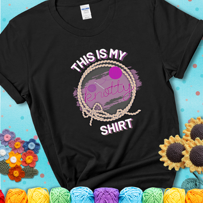 Black t-shirt with the phrase “This is My Knotty Shirt” inside a rope circle, featuring a yarn ball and crochet hook forming the word “knotty.”