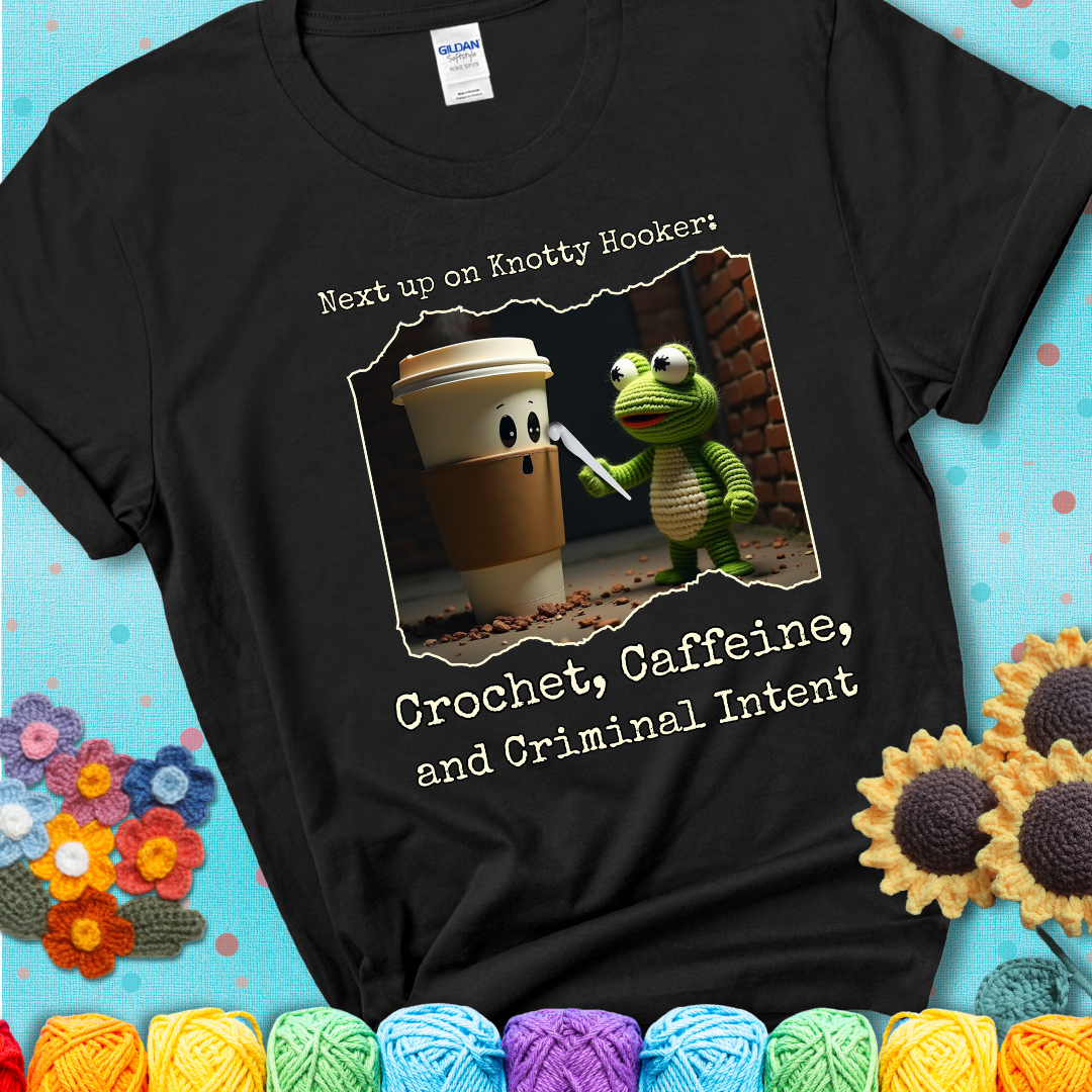 A crocheted frog holding a crochet hook confronts a surprised coffee cup in a dim alleyway with text: "Next up on Knotty Hooker: Crochet, Caffeine, and Criminal Intent," showing a black tee with a teal sunflower background