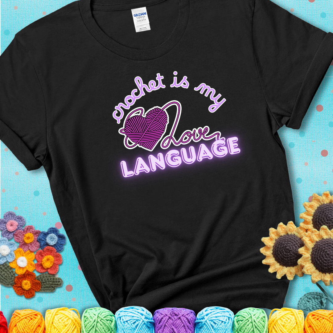 Say it with stitches Design reads 'Crochet Is My Love Language', perfect crochet gift for yarn lovers; showing a black tee with a teal sunflower background