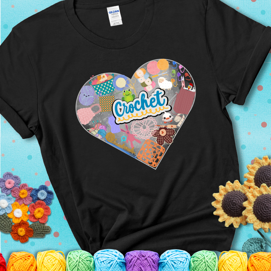 A heart filled with colorful crochet essentials including yarn, hooks, scissors, notions, and handmade items, with the word "Crochet" prominently in the center of a black t-shirt.