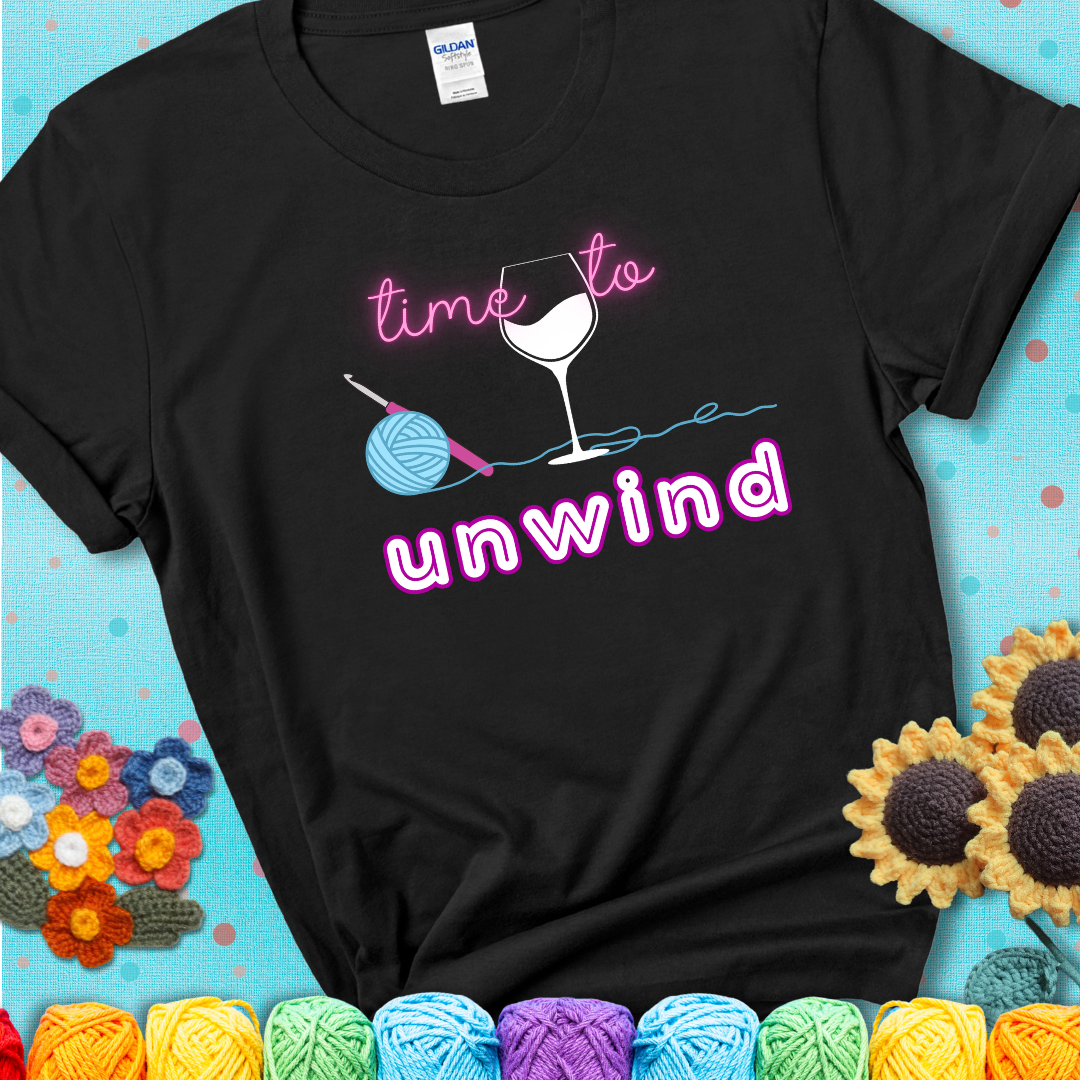 Wine down with your yarn out Design reads 'Time To Unwind' , perfect crochet gift for yarn lovers showing a black tee with a teal sunflower background