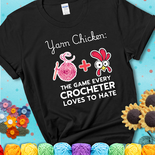 Cartoon chicken inside a yarn ball with crochet circle background. Text reads: “Yarn Chicken: The Game Every Crocheter Loves to Lose.” A fun and relatable tee for fiber artists who like to live on the edge, showing a black tee with a teal sunflower background