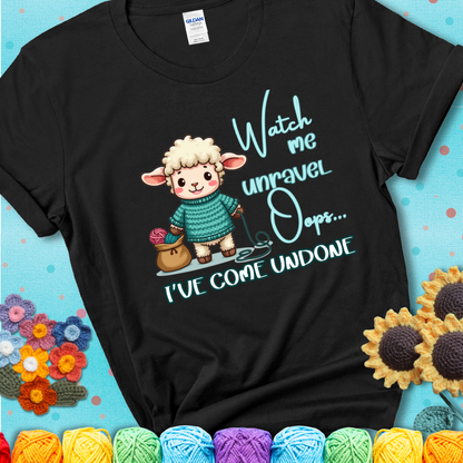 Black t-shirt with a cute sheep holding yarn looks startled with the phrase “Watch me unravel… Oops, I’ve come undone.” Perfect mix of whimsy and yarn life chaos.