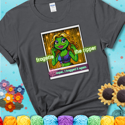 Retro-styled illustration of a glamorous green frog in a sparkly outfit, labeled "Frogette the Ripper" with the phrase “Oops! I frogged it again” below, referencing both crochet and pop culture showing a charcoal grey tee with a teal sunflower background
