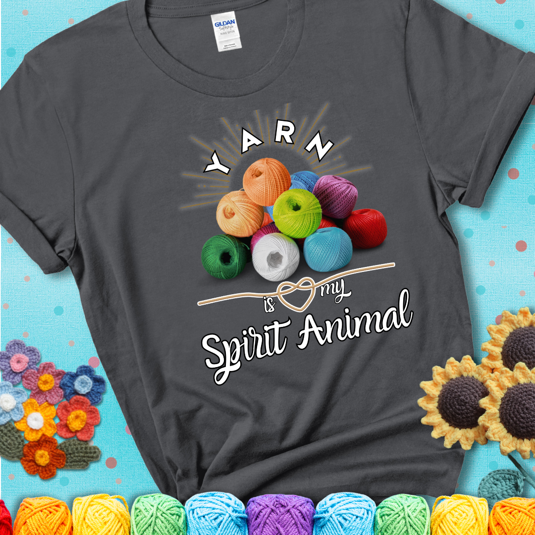 Stack of colorful yarn balls with radiant glow. Text reads: “Yarn Is My Spirit Animal.” A calming and colorful tee for fiber lovers who find zen in stitching, showing a charcoal grey tee with a teal sunflower background