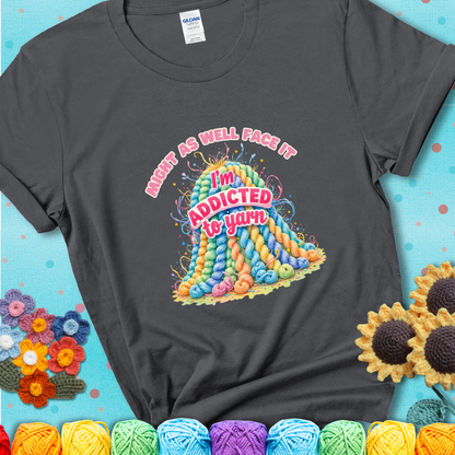 Charcoal t-shirt with a colorful mountain of pastel yarn hanks and the phrase “Might As Well Face It, I’m Addicted To Yarn” in pink and red lettering.