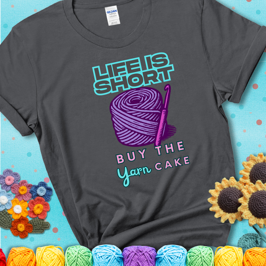No regrets, just yarn. Design reads 'Life Is Short. Buy The Yarn (Cake)' , perfect crochet gift for yarn lovers, showing a charcoal grey tee with a teal sunflower background