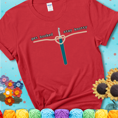 Hooked on yarn? Same Design reads 'Get Hooked, Stay Knotty' , perfect crochet gift for yarn lovers, showing a red tee with a teal sunflower background