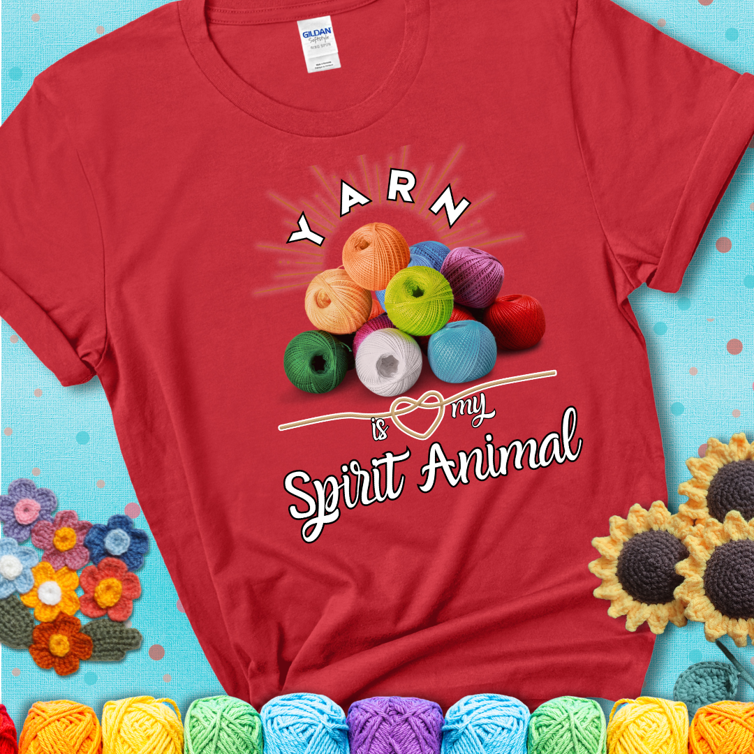 Stack of colorful yarn balls with radiant glow. Text reads: “Yarn Is My Spirit Animal.” A calming and colorful tee for fiber lovers who find zen in stitching, showing a red tee with a teal sunflower background