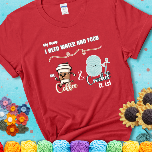 Design reads “My body: I need water and food. Me: Coffee & Crochet it is,” with a smiling coffee cup and yarn ball characters on a red t-shirt.