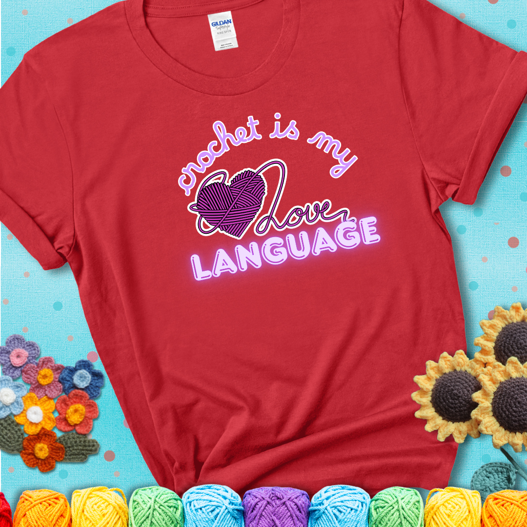Say it with stitches Design reads 'Crochet Is My Love Language', perfect crochet gift for yarn lovers; showing a red tee with a teal sunflower background