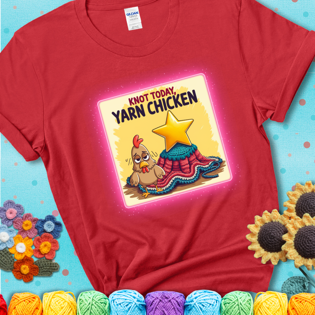 A red t-shirt showing a frazzled cartoon chicken stands next to a nearly-finished project with minimal yarn left, with the phrase “Knot Today, Yarn Chicken” above.