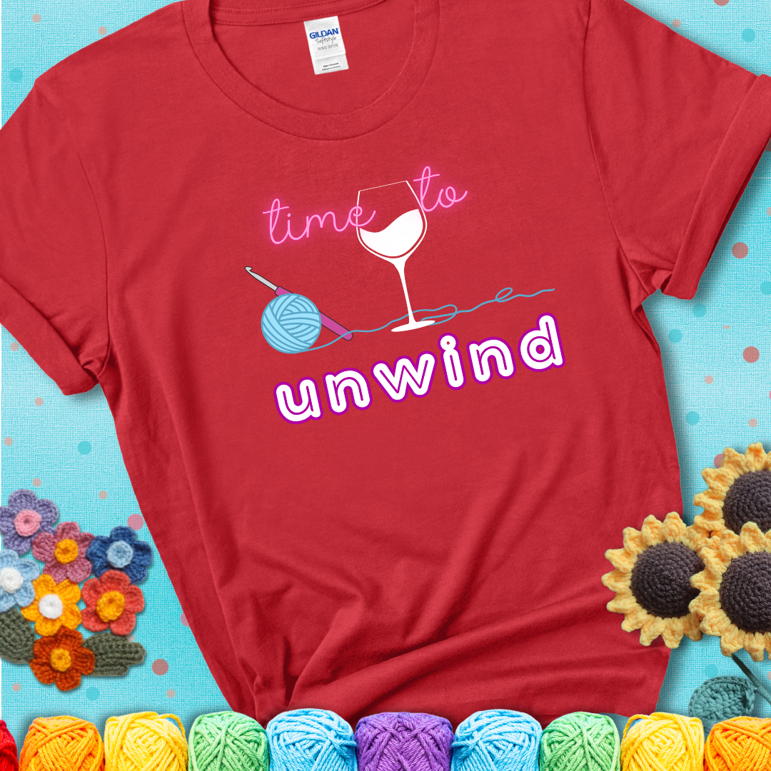 Wine down with your yarn out Design reads 'Time To Unwind' , perfect crochet gift for yarn lovers showing a red tee with a teal sunflower background