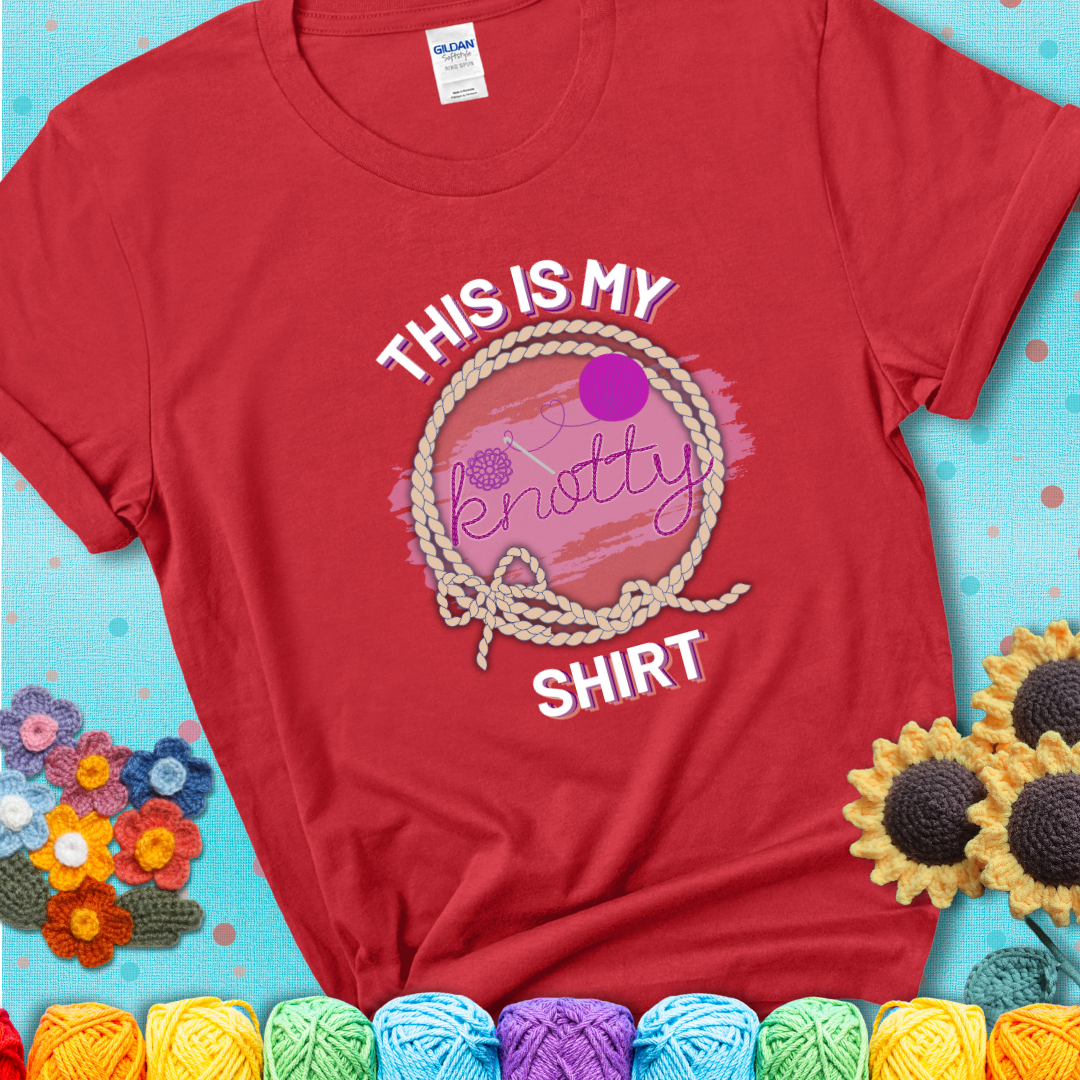 Red t-shirt with the phrase “This is My Knotty Shirt” inside a rope circle, featuring a yarn ball and crochet hook forming the word “knotty.”