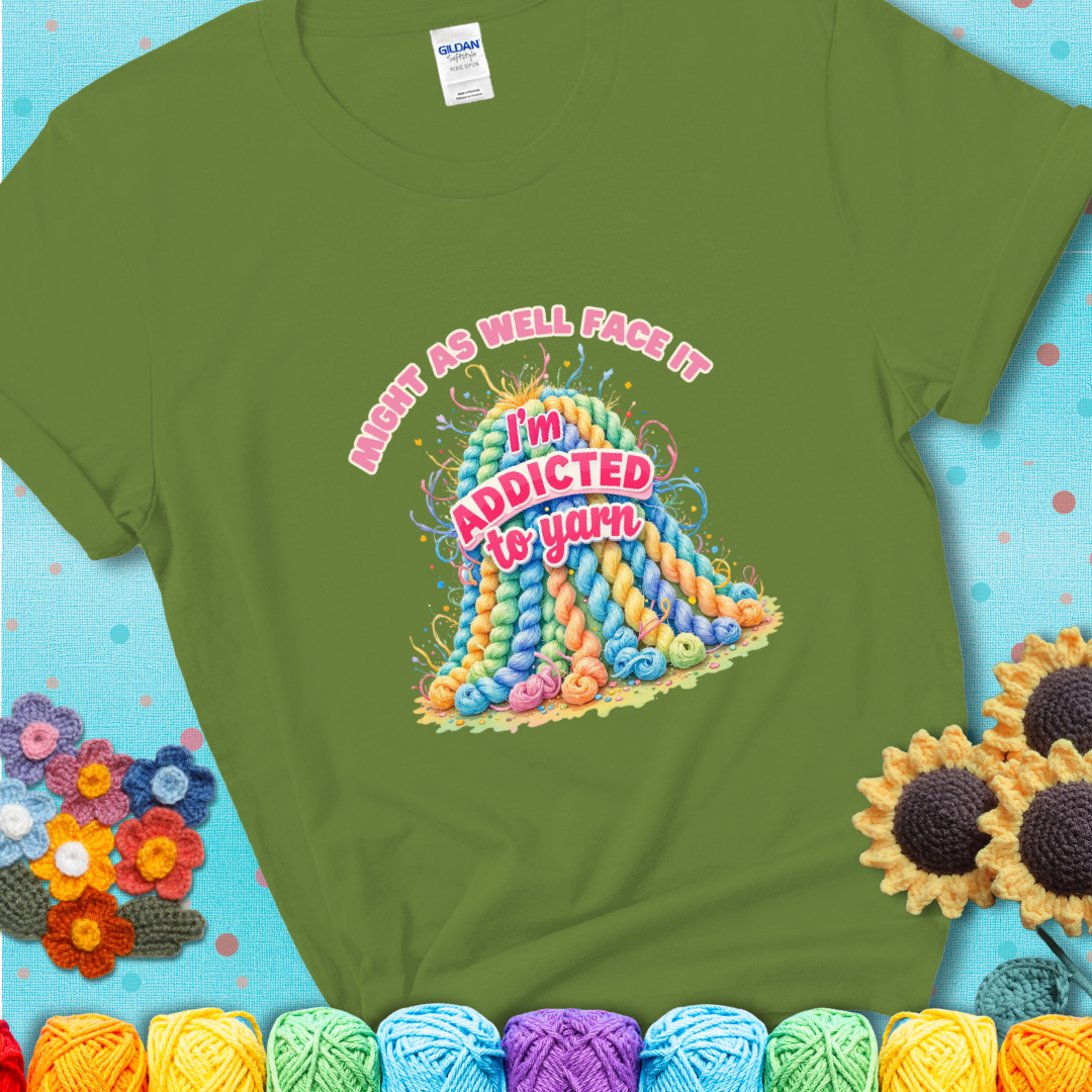Kiwi t-shirt with a colorful mountain of pastel yarn hanks and the phrase “Might As Well Face It, I’m Addicted To Yarn” in pink and red lettering.