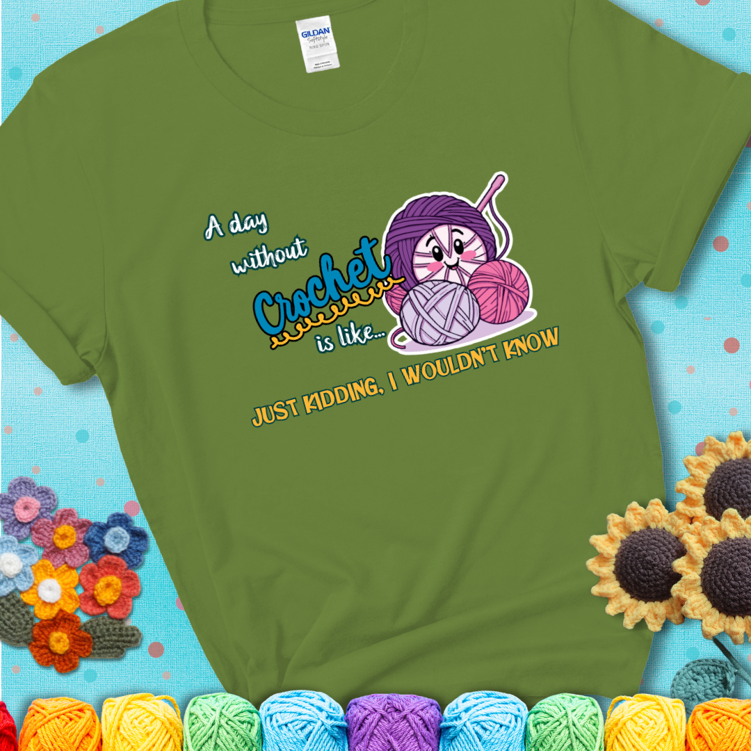 Green t-shirt showing a smiling yarn ball character with text “A day without crochet is like... just kidding, I wouldn’t know”; funny crochet t-shirt.
