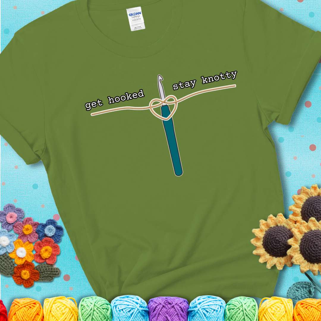 Hooked on yarn? Same Design reads 'Get Hooked, Stay Knotty' , perfect crochet gift for yarn lovers, showing a green tee with a teal sunflower background