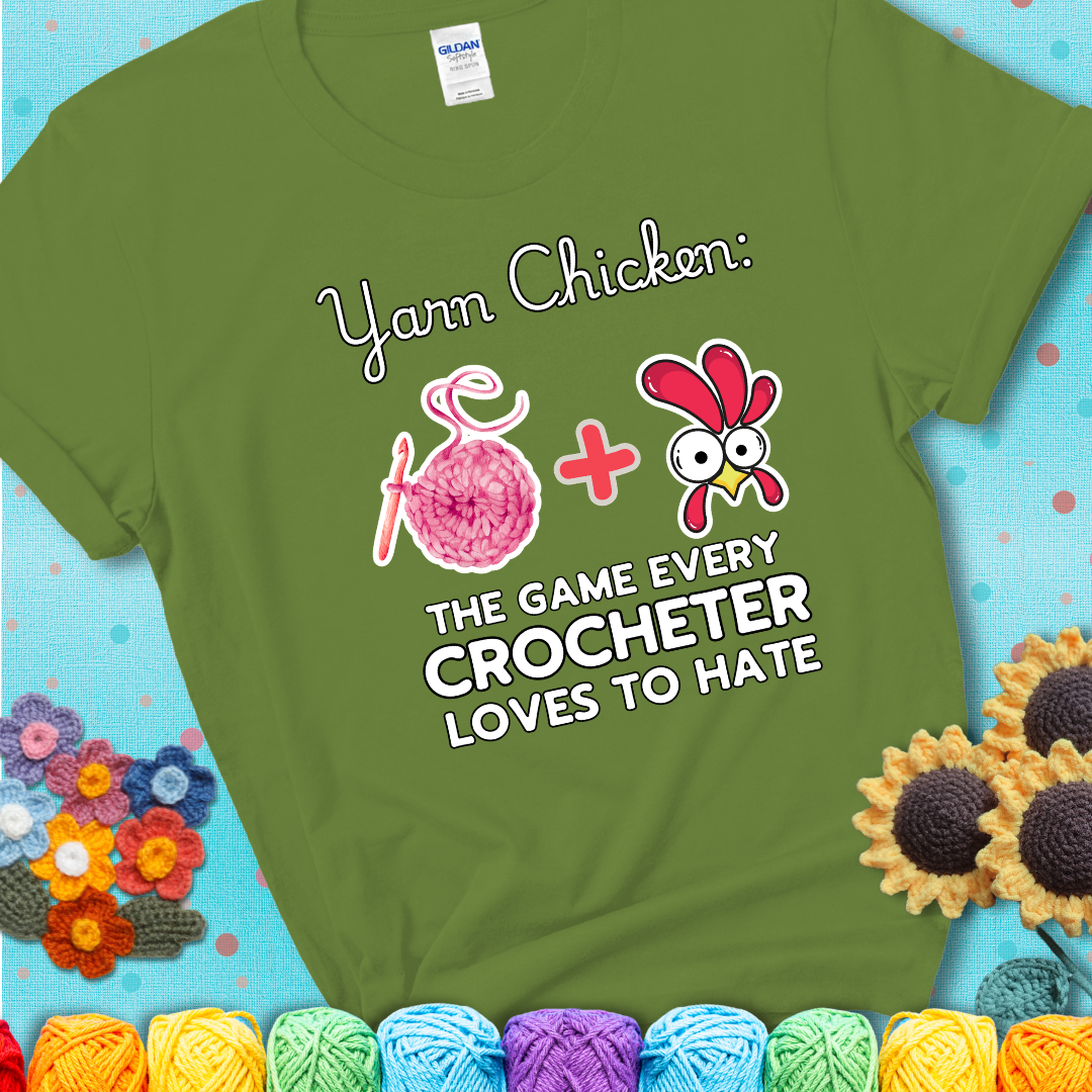 Cartoon chicken inside a yarn ball with crochet circle background. Text reads: “Yarn Chicken: The Game Every Crocheter Loves to Lose.” A fun and relatable tee for fiber artists who like to live on the edge, showing a green tee with a teal sunflower background