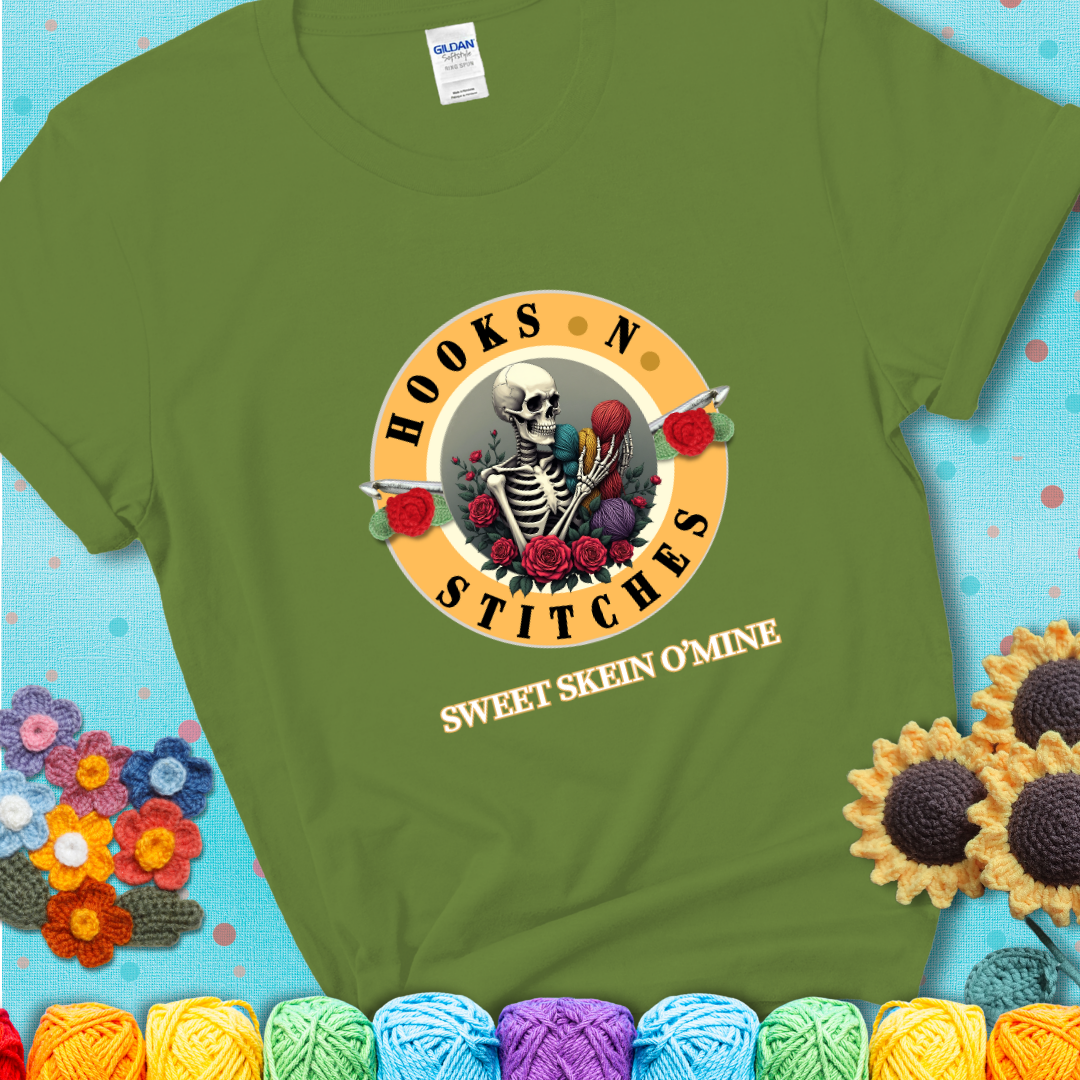 Kiwi t-shirt with a skeleton holding colorful yarn, roses, crochet hooks, and the phrases “Hooks ’N Stitches” and “Sweet Skein O’Mine.”