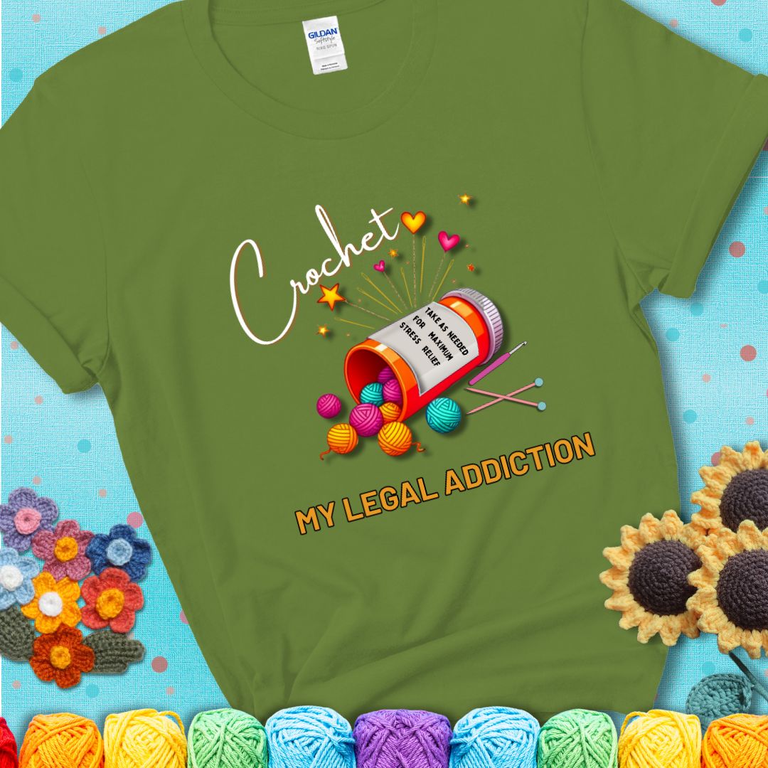 Kiwi t-shirt with a prescription bottle spilling colorful yarn balls, small crochet details, and the phrase “Crochet: My Legal Addiction.”