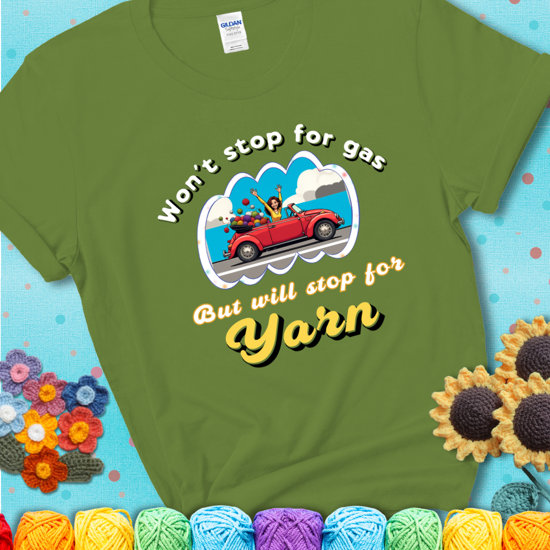 Kiwi t-shirt with a woman driving a red convertible filled with yarn and the phrase “Won't Stop For Gas But Will Stop For Yarn.”