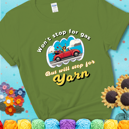 Kiwi t-shirt with a woman driving a red convertible filled with yarn and the phrase “Won't Stop For Gas But Will Stop For Yarn.”
