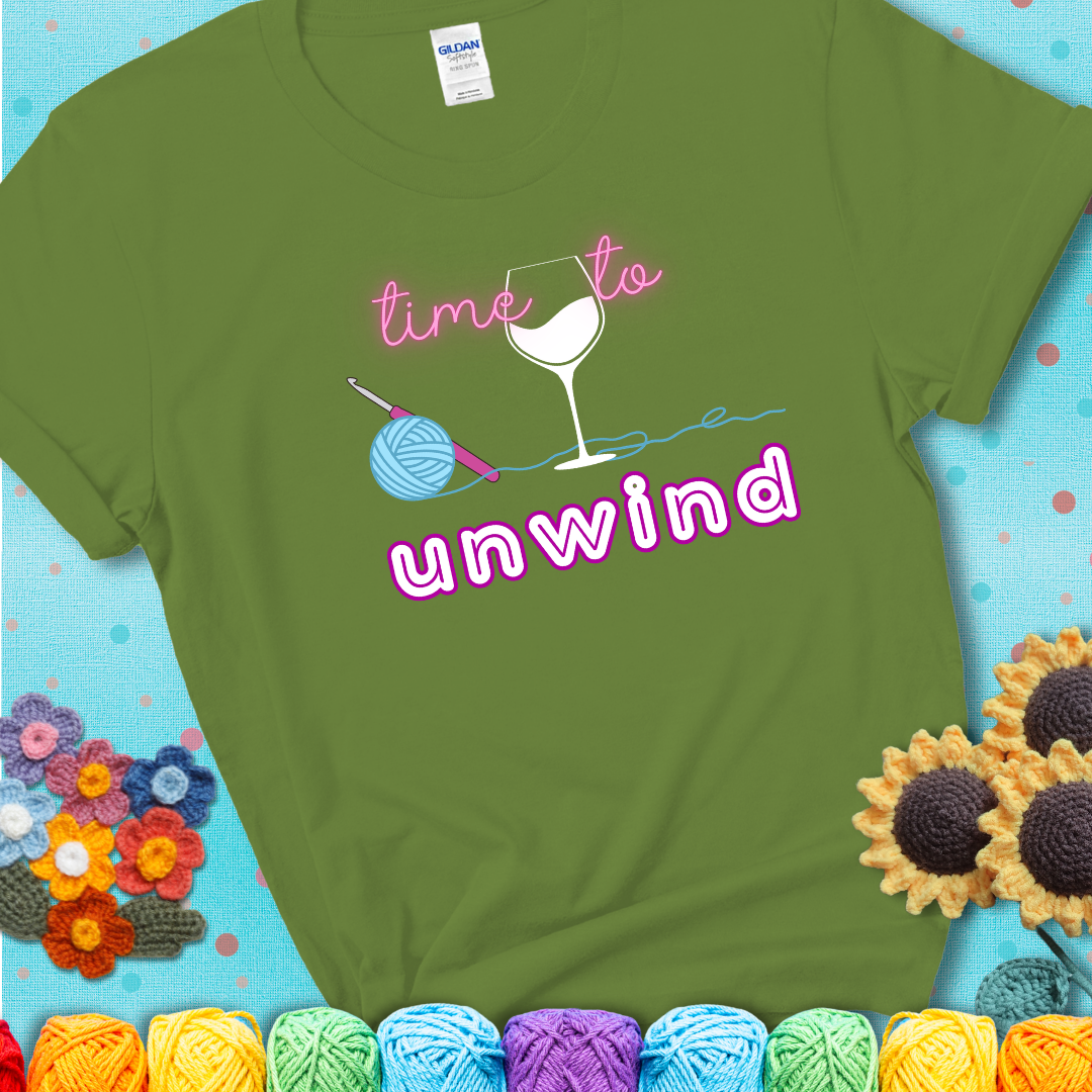Wine down with your yarn out Design reads 'Time To Unwind' , perfect crochet gift for yarn lovers showing a green tee with a teal sunflower background