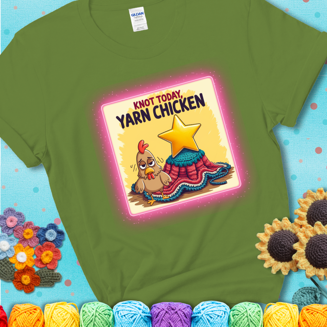 A green t-shirt showing a frazzled cartoon chicken stands next to a nearly-finished project with minimal yarn left, with the phrase “Knot Today, Yarn Chicken” above.