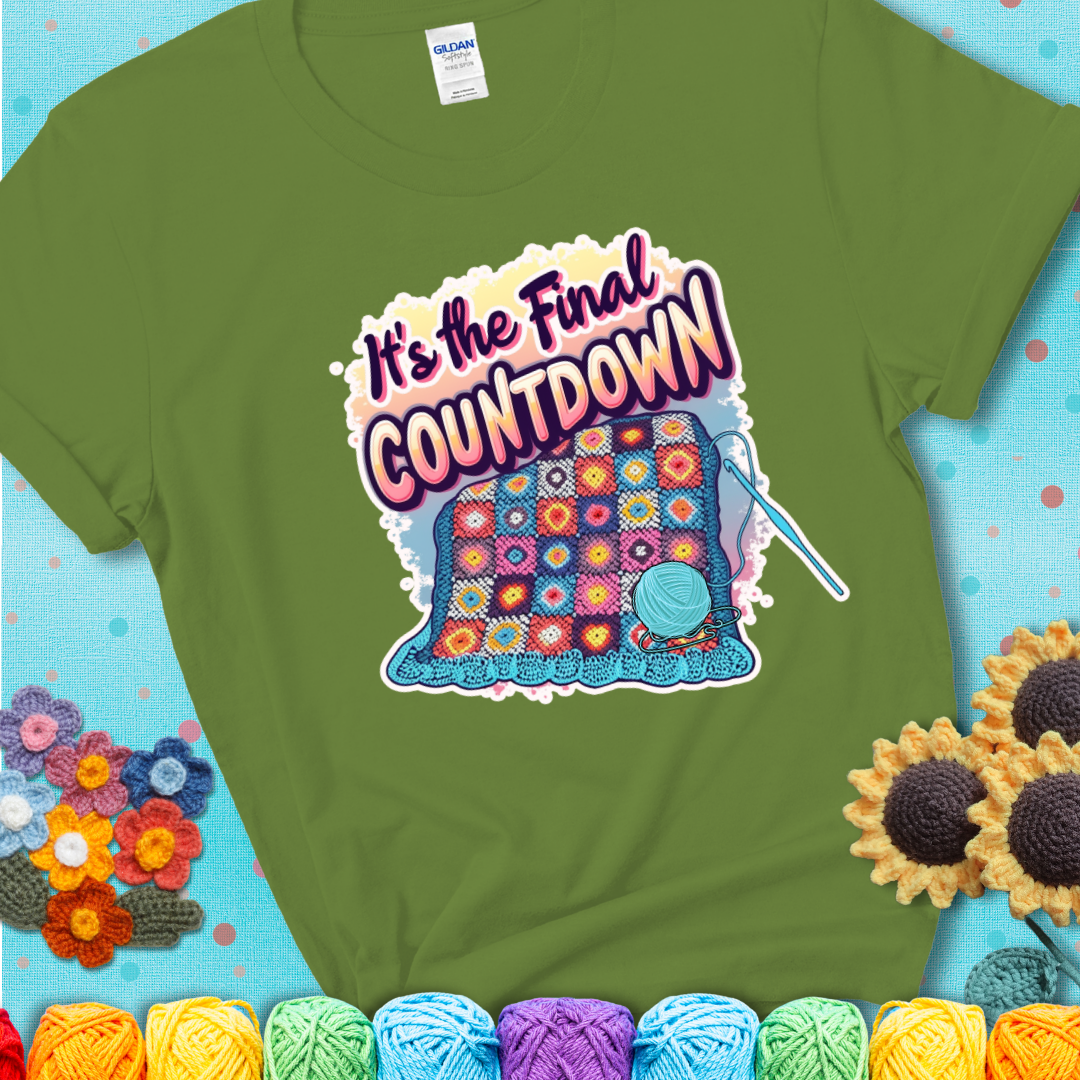 Kiwi t-shirt with a colorful crochet blanket in progress, blue yarn ball, crochet hook, and the phrase “It’s The Final Countdown.”