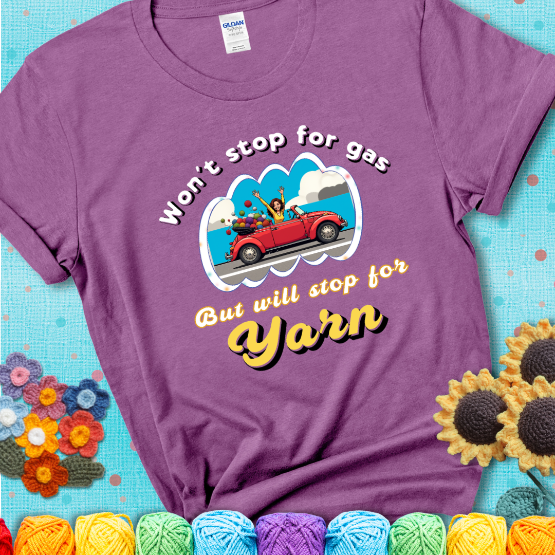 Heather Radiant Orchid t-shirt with a woman driving a red convertible filled with yarn and the phrase “Won't Stop For Gas But Will Stop For Yarn.”