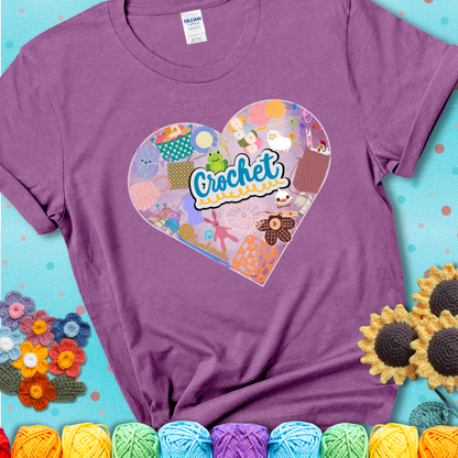A heart filled with colorful crochet essentials including yarn, hooks, scissors, notions, and handmade items, with the word "Crochet" prominently in the center of a light purple t-shirt.