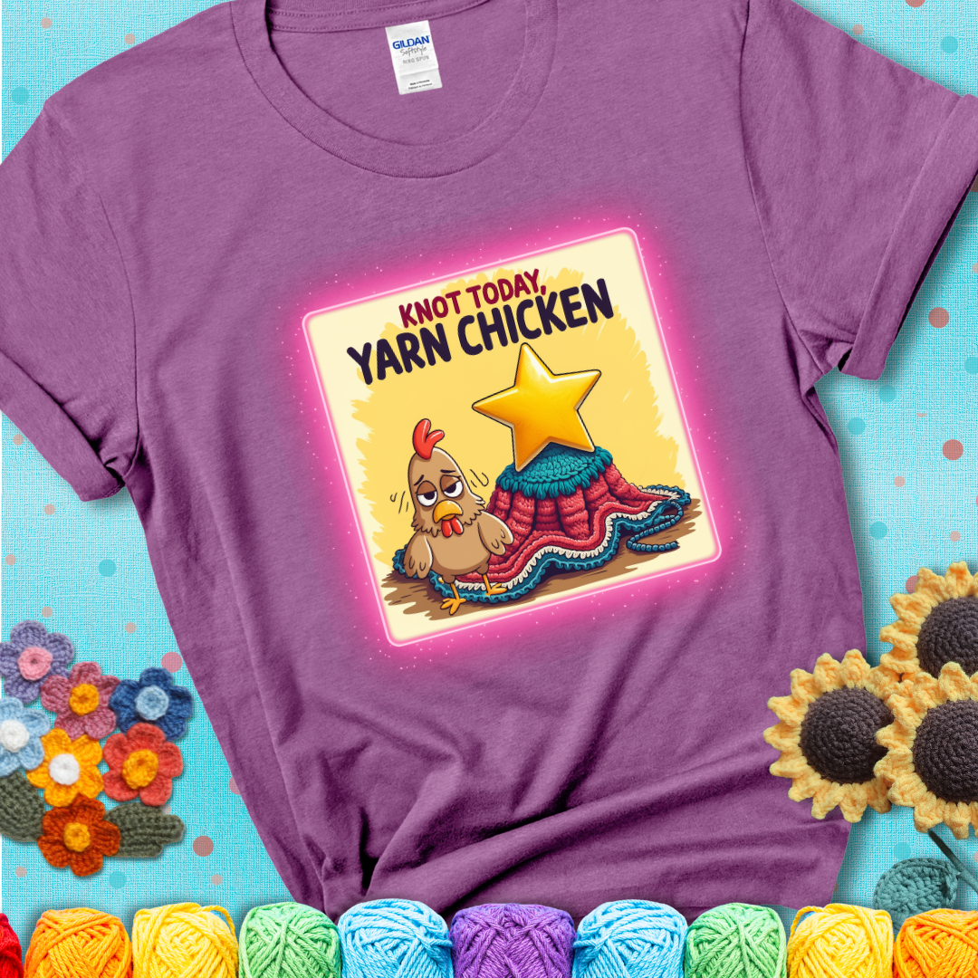 A light purple t-shirt showing a frazzled cartoon chicken stands next to a nearly-finished project with minimal yarn left, with the phrase “Knot Today, Yarn Chicken” above.