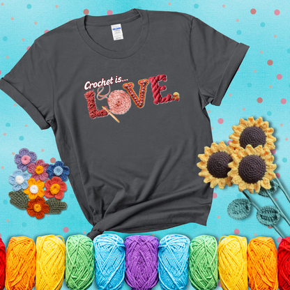 The word "LOVE" spelled with different crochet textures and yarn in red tones, with the phrase “Crochet is…” above in script. showing a pink tee with a teal sunflower background