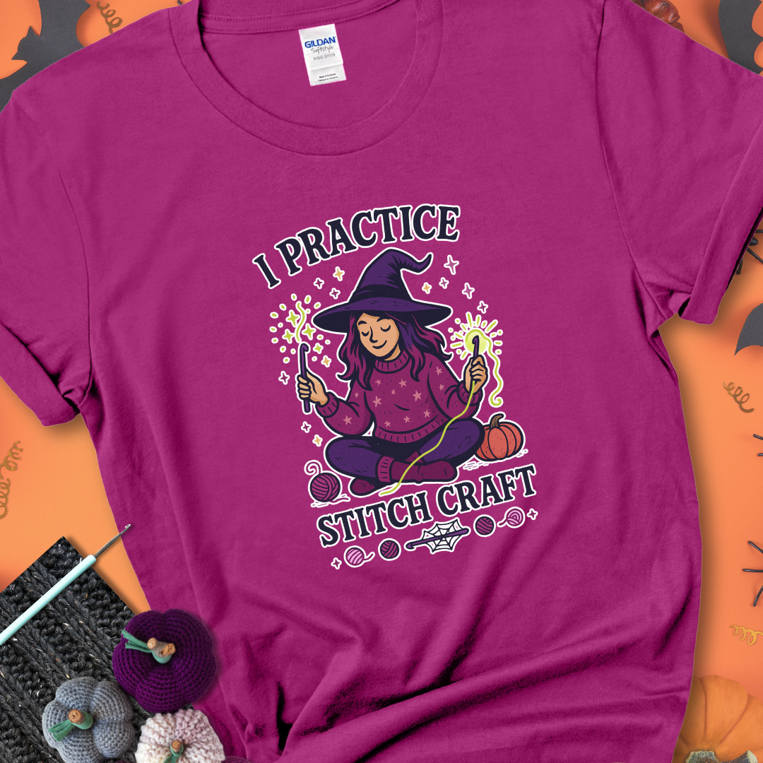 Antique Heliconia t-shirt with a witchy crocheter conjuring glowing yarn with crochet hooks, surrounded by stars and pumpkins, with the phrase “I Practice Stitch Craft.”