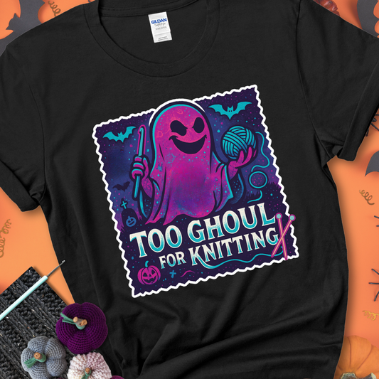 Black t-shirt with a ghost holding a crochet hook and ball of yarn, with the phrase “Too Ghoul for Knitting” in purple, teal, and white.