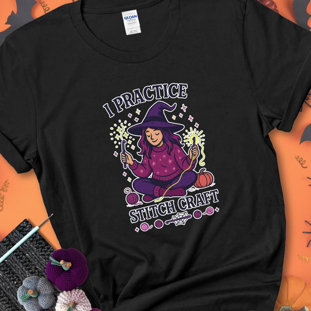 Black t-shirt with a witchy crocheter conjuring glowing yarn with crochet hooks, surrounded by stars and pumpkins, with the phrase “I Practice Stitch Craft.”