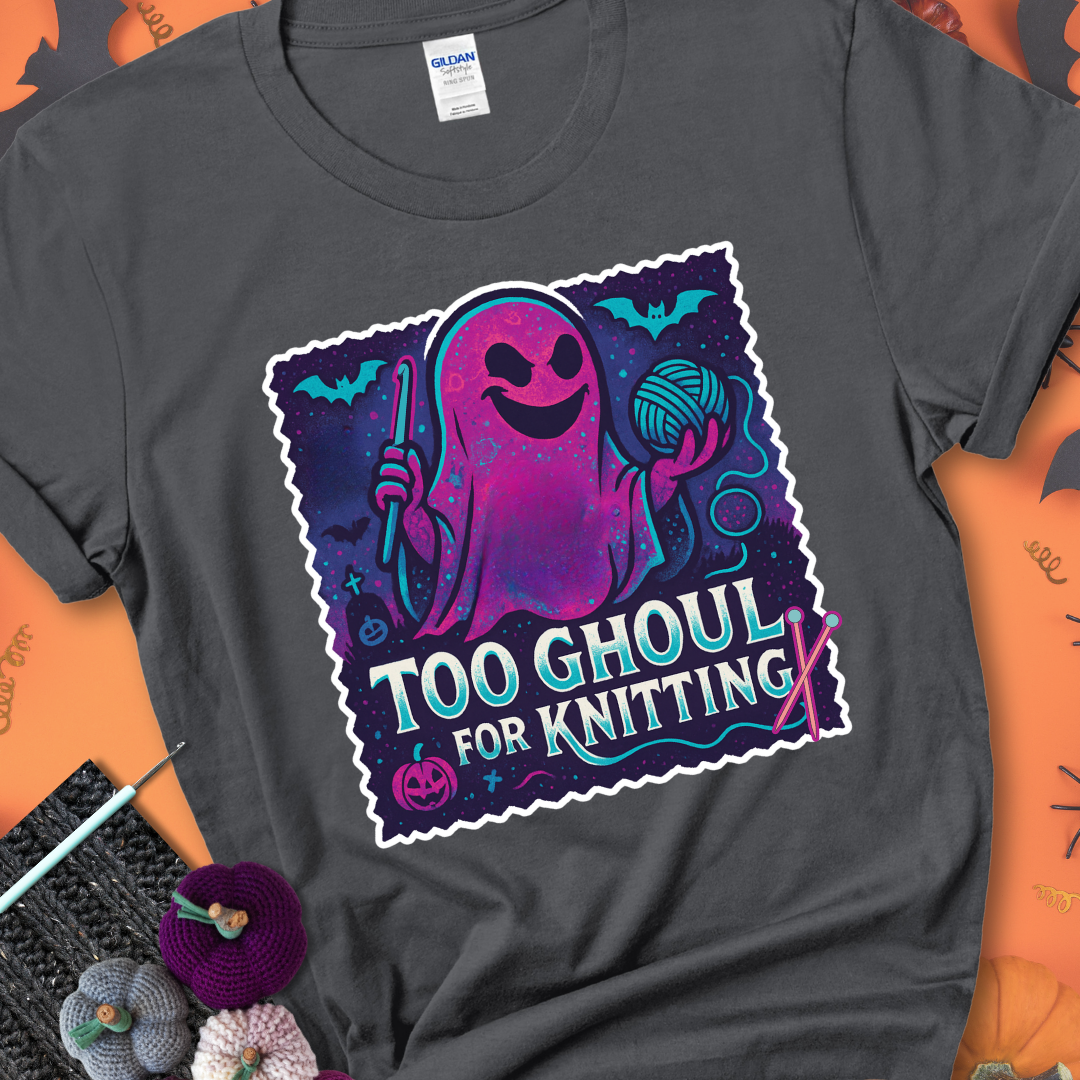 Charcoal t-shirt with a ghost holding a crochet hook and ball of yarn, with the phrase “Too Ghoul for Knitting” in purple, teal, and white.