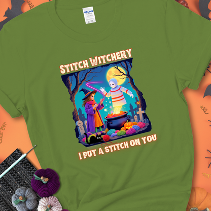 Kiwi t-shirt with a yarn witch casting a spell from a cauldron onto a floating crochet ghost, with text “Stitch Witchery” and “I Put a Stitch on You.”