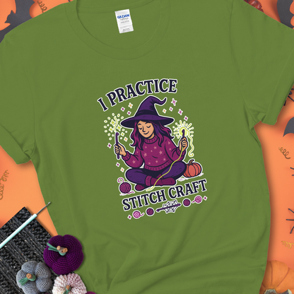 Kiwi t-shirt with a witchy crocheter conjuring glowing yarn with crochet hooks, surrounded by stars and pumpkins, with the phrase “I Practice Stitch Craft.”
