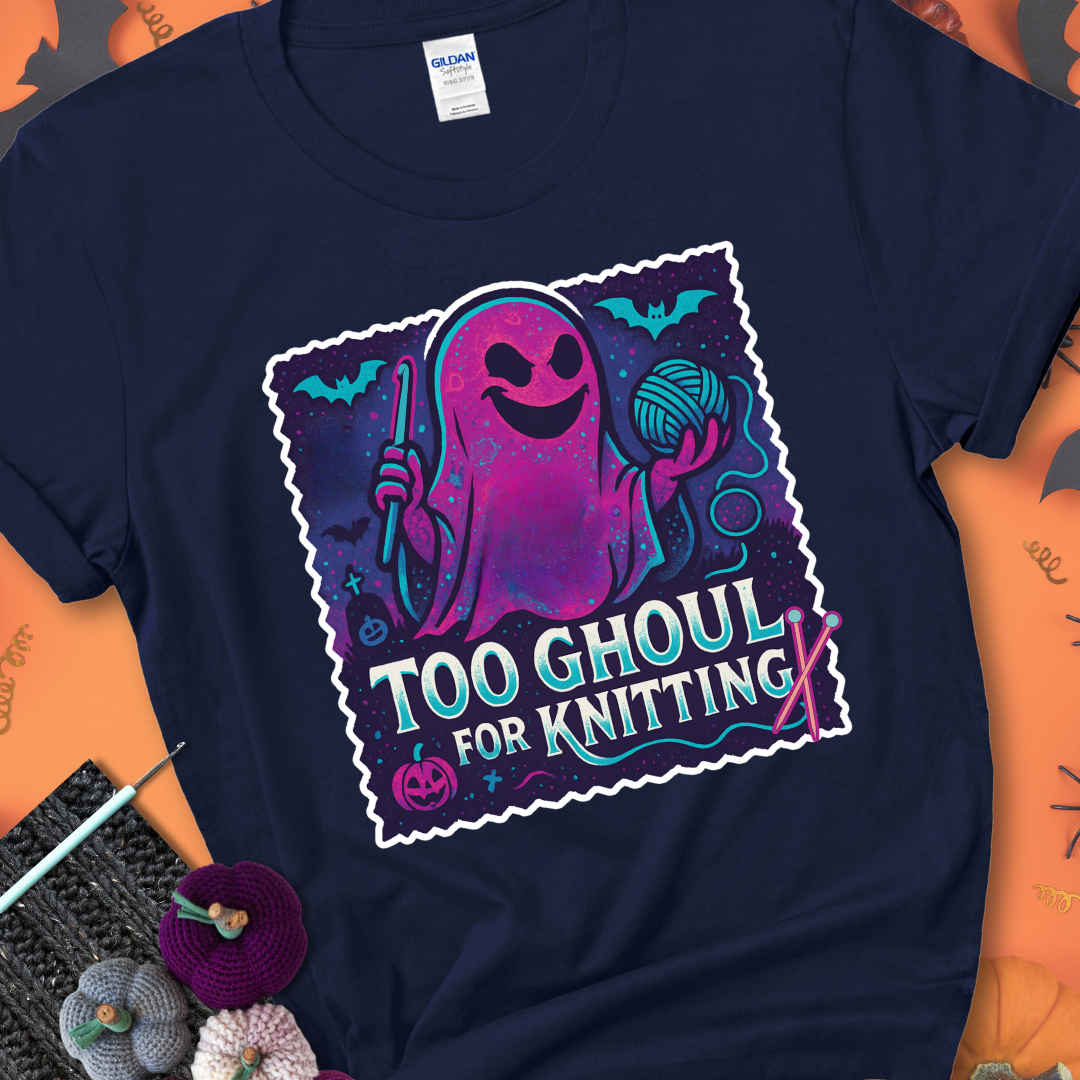 Navy t-shirt with a ghost holding a crochet hook and ball of yarn, with the phrase “Too Ghoul for Knitting” in purple, teal, and white.